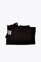 A folded Free Gift Urban Slate Waterproof bag in black with a looped handle and partial white lettering, shown against a plain white background for organized, on-the-go convenience.