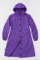 A long, hooded purple Icon Milano Windbreaker Rain Jacket featuring black buttons, an adjustable drawstring at the hood, two side pockets, and elastic cuffs; this stylish water-resistant jacket is displayed against a plain white background.