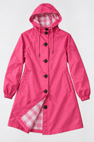 Introducing the Icon Milano Windbreaker Rain Jacket, a vibrant pink women’s outerwear piece inspired by Italian design. This hooded raincoat features stylish black buttons, elastic cuffs, and practical side pockets. The interior showcases a chic pink and white plaid lining. Crafted to be water-resistant, this jacket is elegantly displayed against a flat, light background.