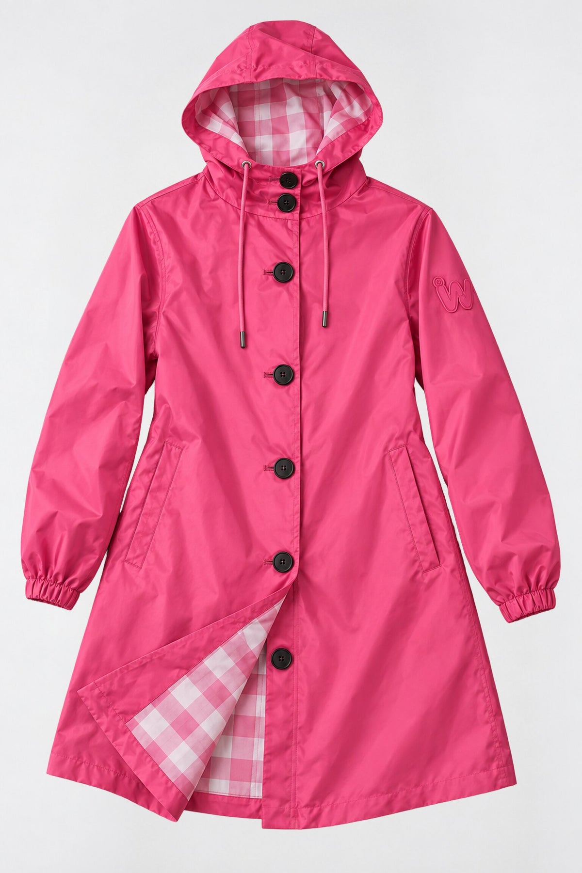 Introducing the Icon Milano Windbreaker Rain Jacket, a vibrant pink women’s outerwear piece inspired by Italian design. This hooded raincoat features stylish black buttons, elastic cuffs, and practical side pockets. The interior showcases a chic pink and white plaid lining. Crafted to be water-resistant, this jacket is elegantly displayed against a flat, light background.